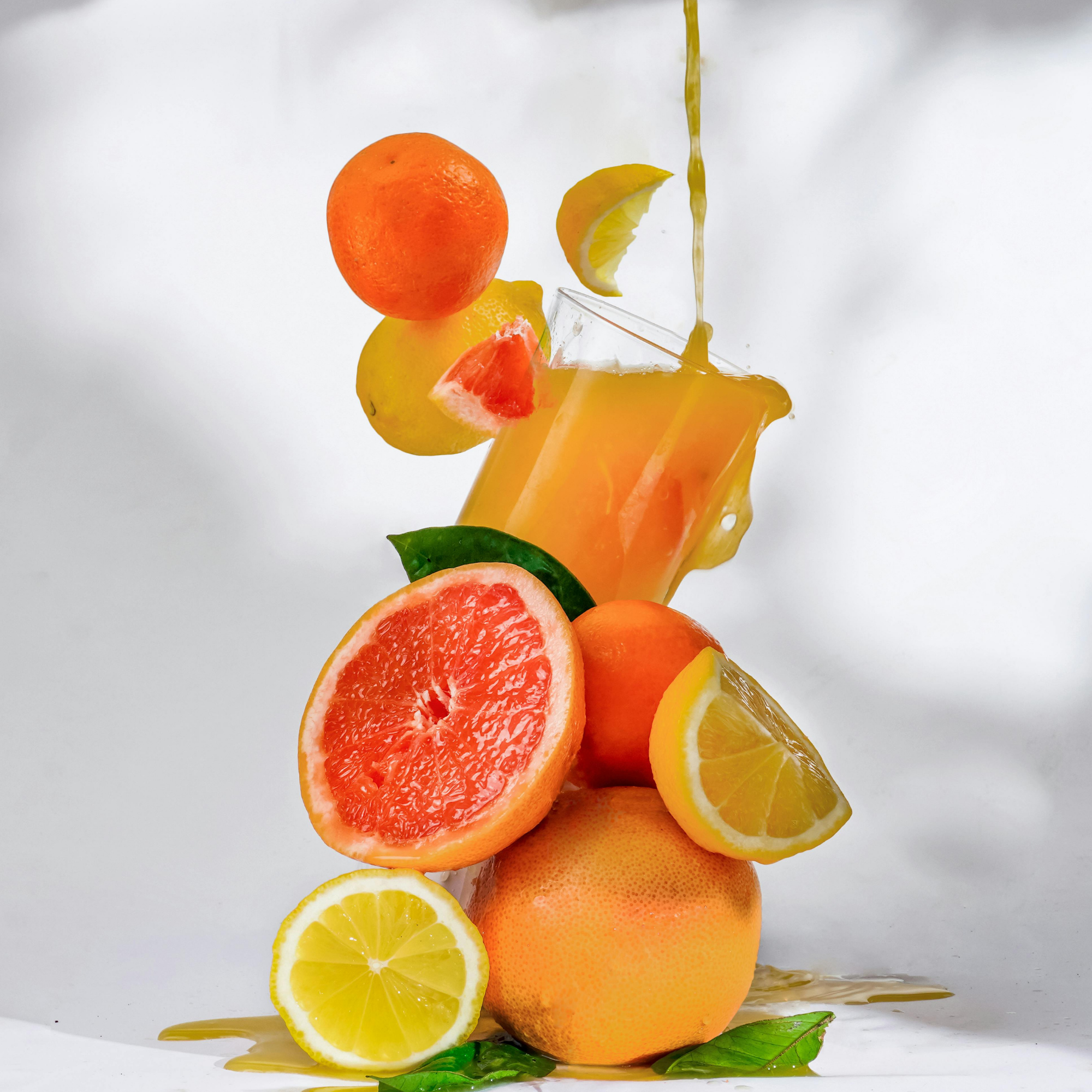Colorful bubble tea drinks served in plastic cups with fresh fruits and pink background.